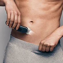 Image of a man using the groomer to shave his stomach