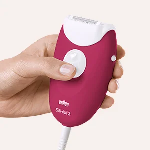Braun Silk-épil 3 epilator in pink, held in a hand, ready for use.