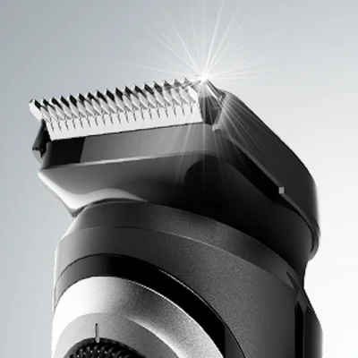 Braun trimmer head, highlighting the precision blades with a bright light reflecting off the cutting edge.