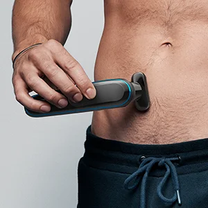 Braun body groomer being used on a man's torso, demonstrating body hair removal.