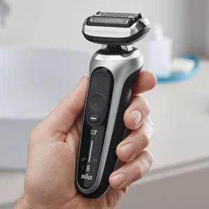 Braun Series 7 electric shaver held in hand, showcasing its ergonomic design and flexible head.