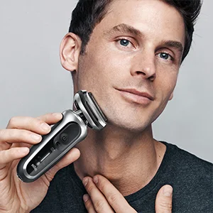 Braun shaver being used by a man to shave his face, demonstrating the product in use.
