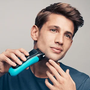 Braun shaver being used by a man to shave his beard.