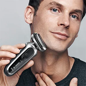 Braun Series 7 electric shaver being used on a man's face.