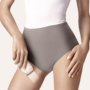 Braun epilator demonstrating hair removal on a woman's thigh.