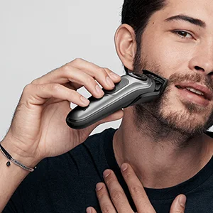 Braun Series 9 Pro electric shaver being used by a man to shave his cheek.