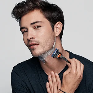 Man shaving his neck with a Braun razor, demonstrating a close and comfortable shave.