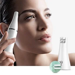 Braun Face Mini Hair Remover being used on a woman's eyebrow, with a 10x magnification detail shown.