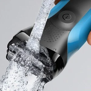 Braun electric shaver being rinsed under running water, highlighting its waterproof design.
