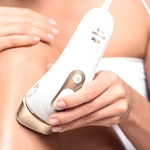 Braun Silk-expert Pro 5 being used on skin, demonstrating hair removal.