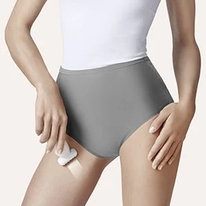 Braun device being used on a woman's upper thigh to remove hair.