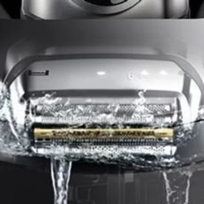 Braun shaver head under running water, demonstrating its wet-and-dry functionality.