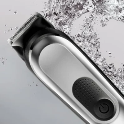 Braun trimmer shown with water splashing, highlighting its waterproof functionality.