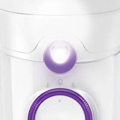 Braun device close-up showing the power button illuminated and a purple dial.