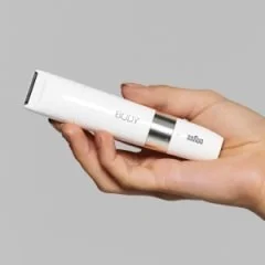 Braun Body Mini Trimmer held in hand, showcasing its compact size and sleek white design.