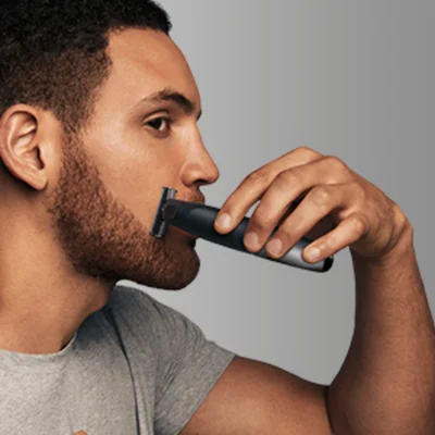 Braun trimmer being used to edge beard.