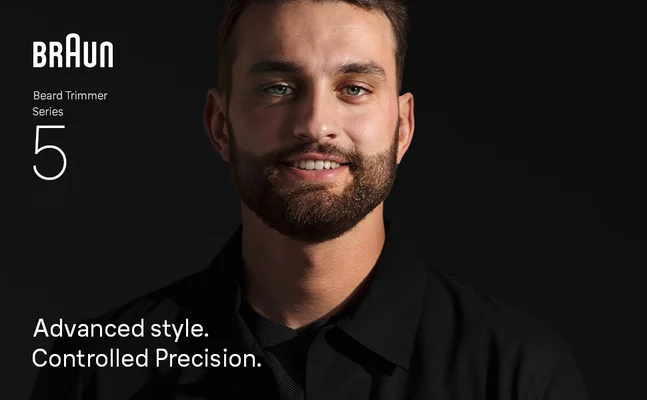 Young man with beard smiling confidently after using Braun Beard Trimmer Series 5