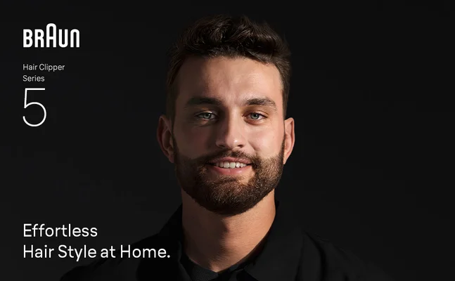 Young man smiling confidently after using the Braun hair clippers for men Series 5