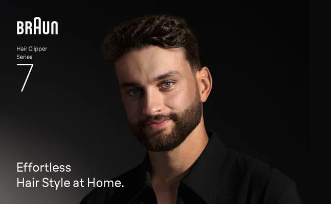 Young man smiling confidently after using the Braun hair clippers for men Series 7