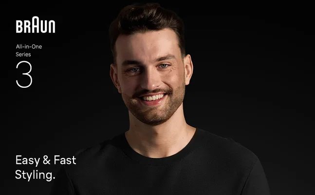 Young man with beard smiling confidently after using the Braun all in one trimmer 3.