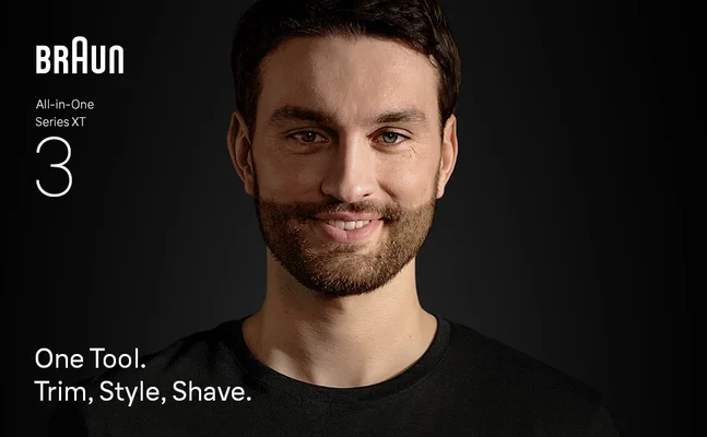 Young man with beard smiling confidently after using the XT Braun all in one trimmer 3