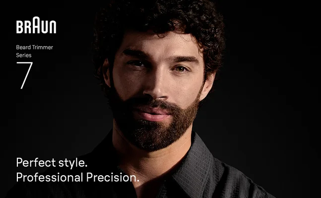 Young man with beard smiling confidently after using Braun Beard Trimmer Series 7