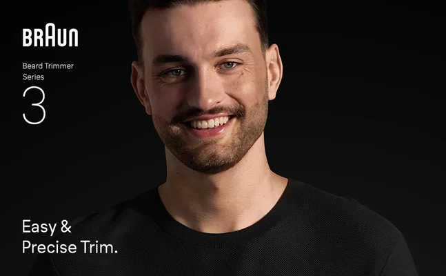 Young man with beard smiling confidently after using Braun Beard Trimmer Series 3