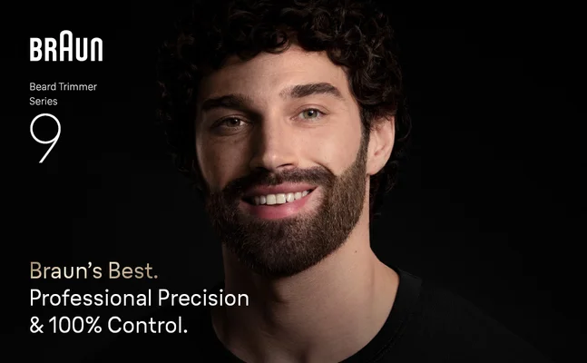 Young man with beard smiling confidently after using Braun Beard Trimmer Series 9