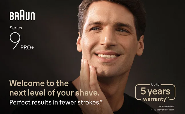 A man smiling, gently touching his shaven face. Texts says perfect results in fewer strokes.