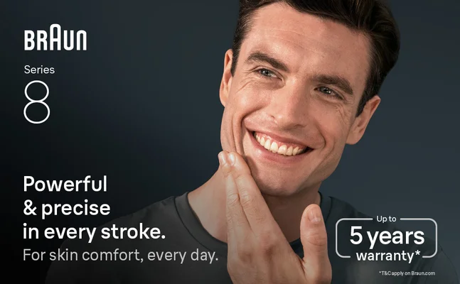 A man smiling, gently touching his shaven face. Texts says 'powerful & precise in every stroke'.