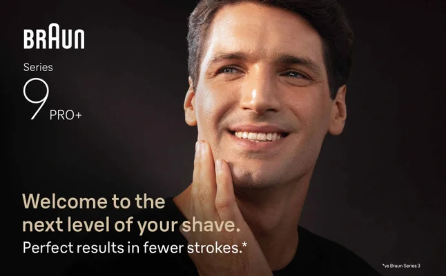 A man smiling, gently touching his shaven face. Texts says 'Perfect results in fewer strokes'.