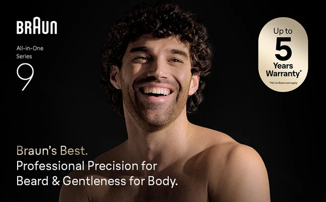 Man smiling with Braun All-in-One Series 9 trimmer, highlighting professional grooming.