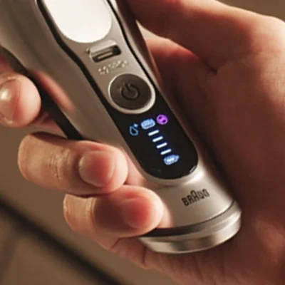 Braun Series 9 PRO+ electric shaver handle with digital display showing shaving modes and battery status.