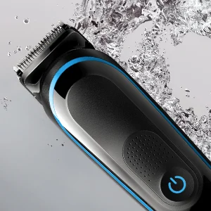 Braun trimmer close-up with water splashing, highlighting its waterproof design for wet and dry use.