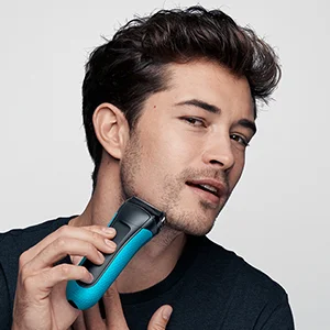 Braun Series 3 electric shaver being used by a man to shave his cheek.