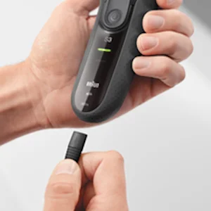Braun Series 3 electric shaver with a hand attaching a precision trimmer head.