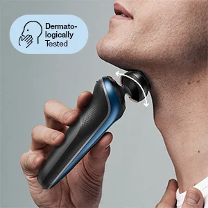 A person shaves their neck with a black and blue electric shaver showing its swiveling head, with the graphic text Dermatologically Tested.