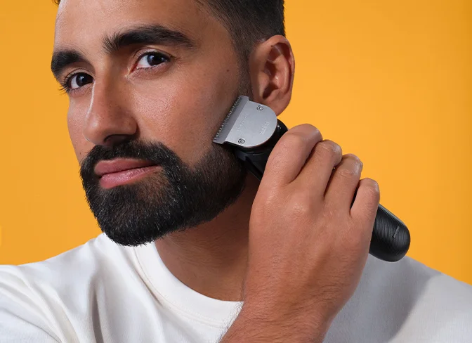 Beard Trimmers - Braun -  man using beard trimmer to shape his beard