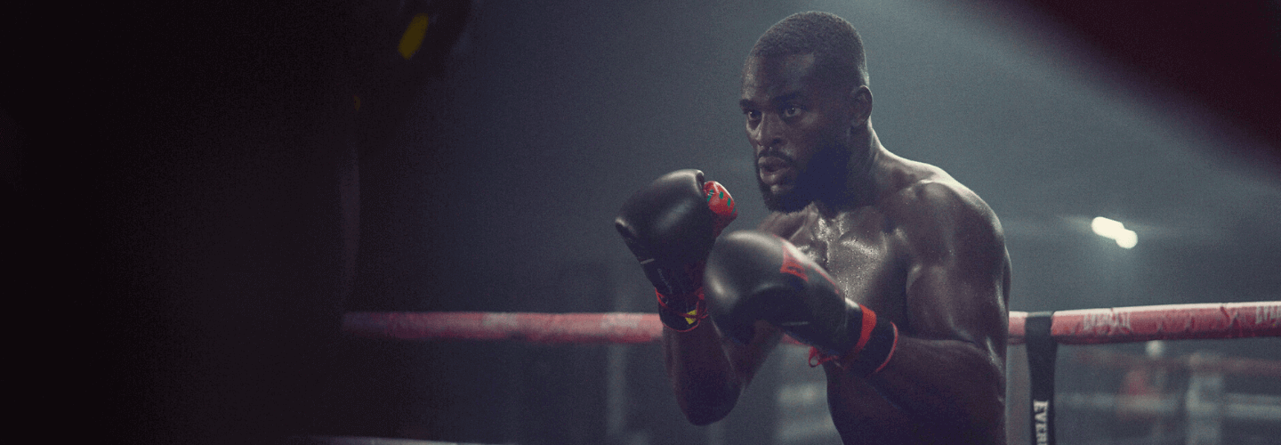 referrals banner image - shirtless man in boxing ring with boxing gloves on