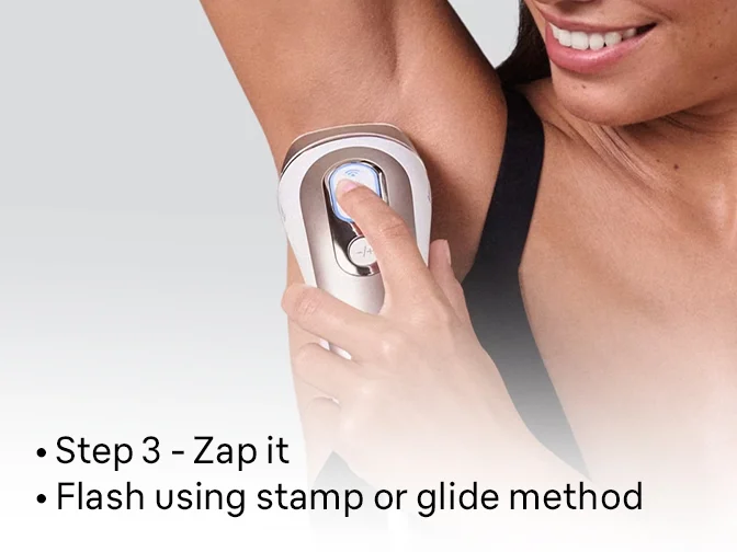 Woman using IPL on underarm. Step 3: Flash using the stamping or gliding method to treat the area