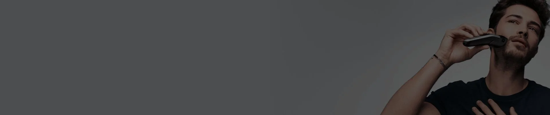 Man using Braun Trimmer - man trimming his stubble beard with an Braun 10-in-1 All-in-one Trimmer 7 MGK7220 with attachment